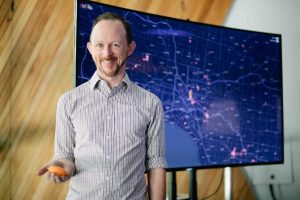Matthew Butler holding a stress pendant