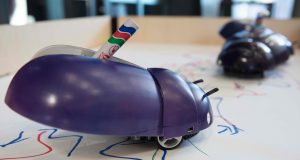 Robot with insect appearance and pen attached