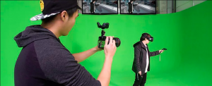 Filming a man with a VR headset on against a green screen