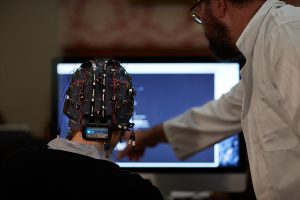 Back of a man's head who is wearing EEG