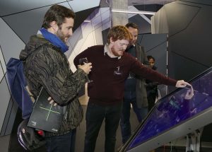 Two men looking at interactive screen