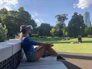 A lady sat with a VR headset on