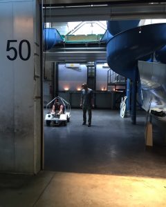 A person wearing a VR headset in a small buggy