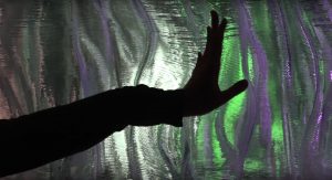 A screenshot from RemeIt. A hand caresses a wall