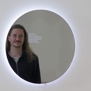 A person looking into the Mirror Ritual mirror